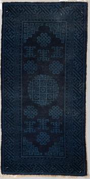 A RUG, a semi-antique Baotou, ca 108 x 54,5 cm.
