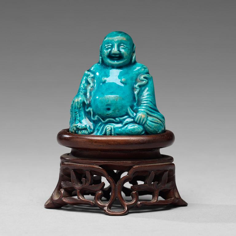 A turquoise glazed figure of Buddai, Qing dynasty, early 18th Century.