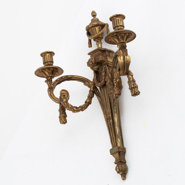 A pair of Louis XVI-style bronze wall sconces, late 19th century.