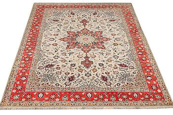 A Tabriz, part silk carpet, c. 300 x 199 cm.