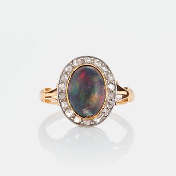 976. An opal ring set with rose-cut diamonds.