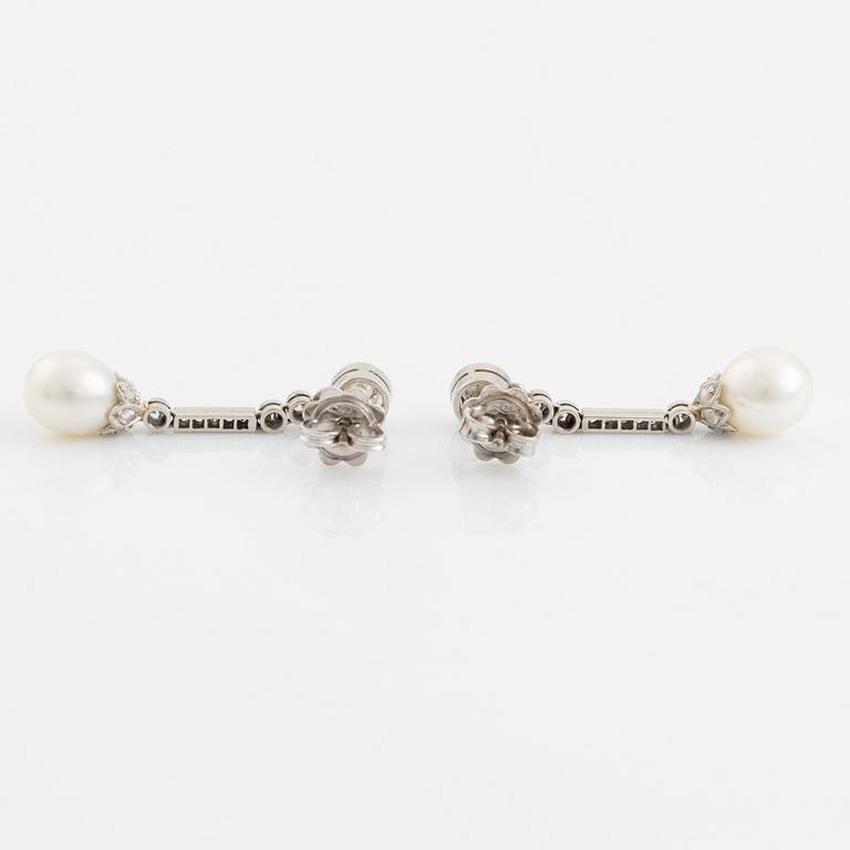 A pair of platinum pearl earings.