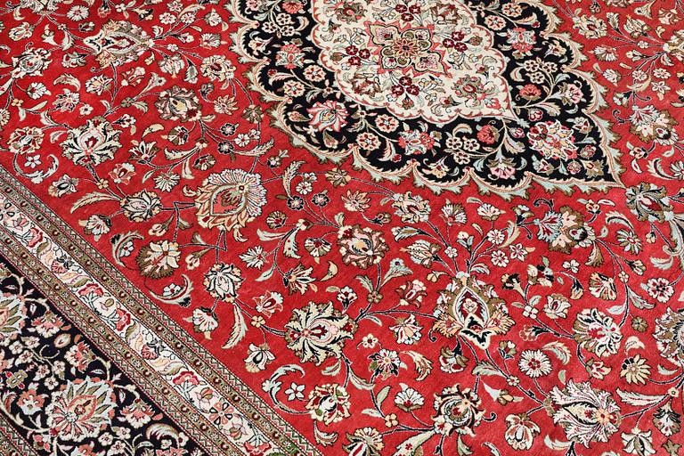 A silk Ghom carpet, c. 346 x 247 cm.