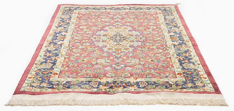 A silk Qum rug, Central Iran, signed, c. 170 x 101 cm.