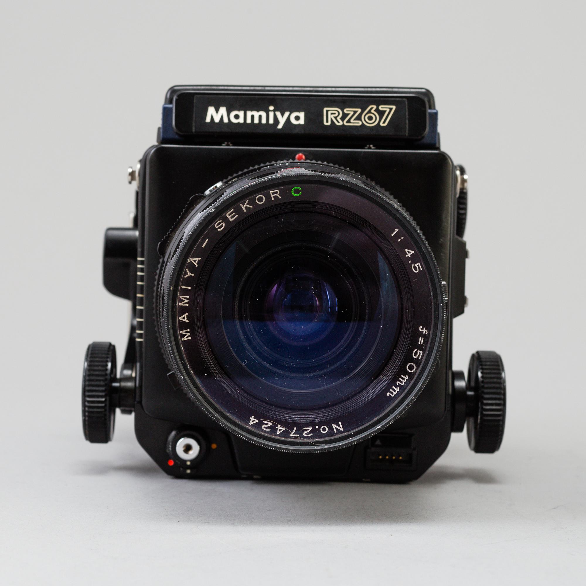 A black Mamiya RZ67 Pro Medium Format Camera Body with sekor z f = 110 mm 1:2.8 and sekor c f = 50 mm 1:4.5 lens.