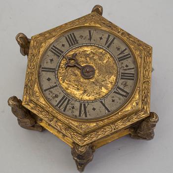 A gilded brass baroque travel clock from around 1700, with original case.