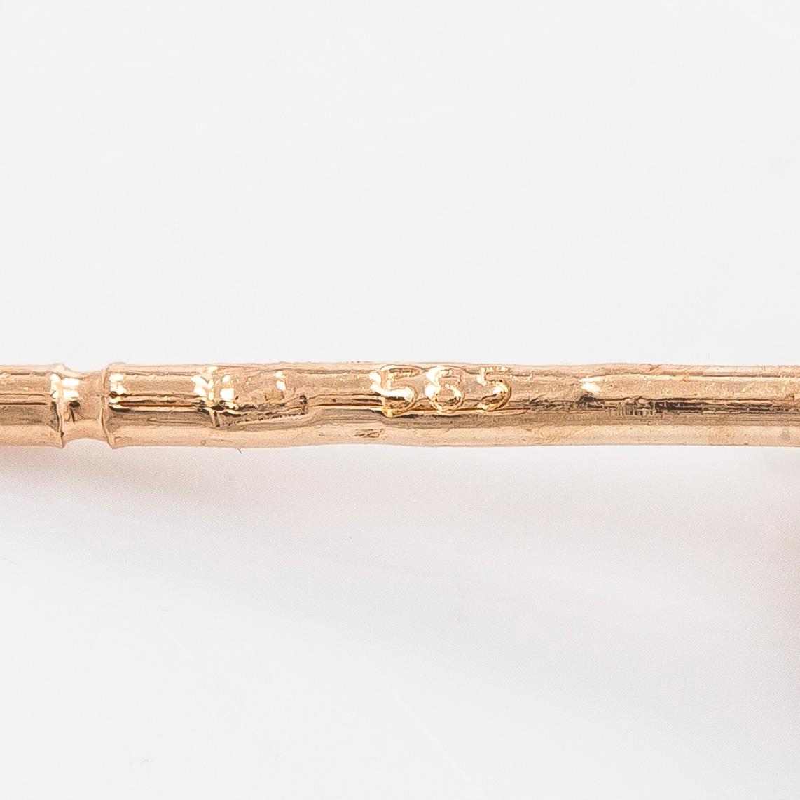 A pair of 14K gold earrings and brilliant cut diamonds.