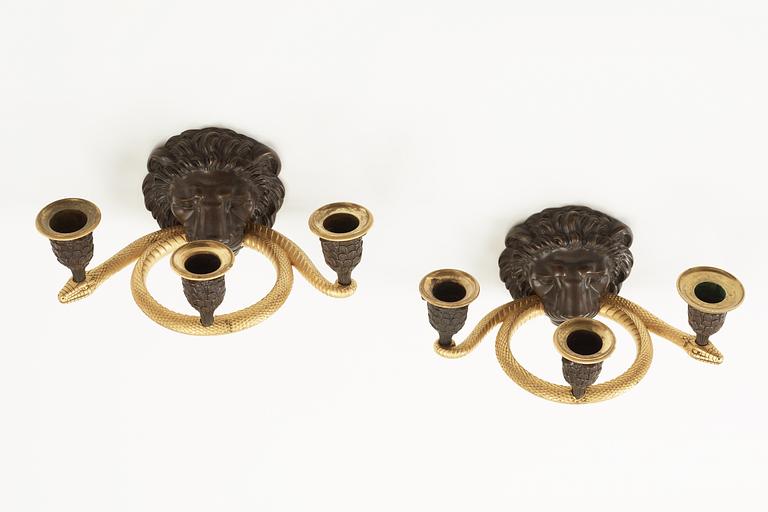 A pair of Empire early 19th Century three-light wall-lights.