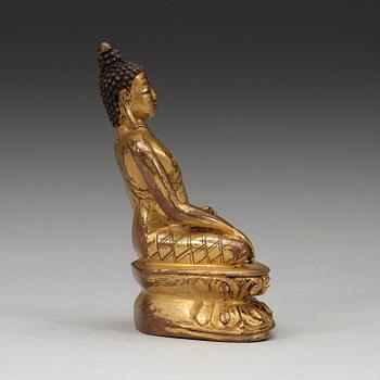A gilt copper-alloy figure of Aksobhya Buddha, 15th/16th century, Tibet or Nepal.