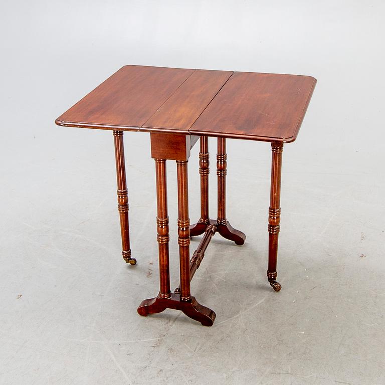 A 20th century English mahogany folding table.