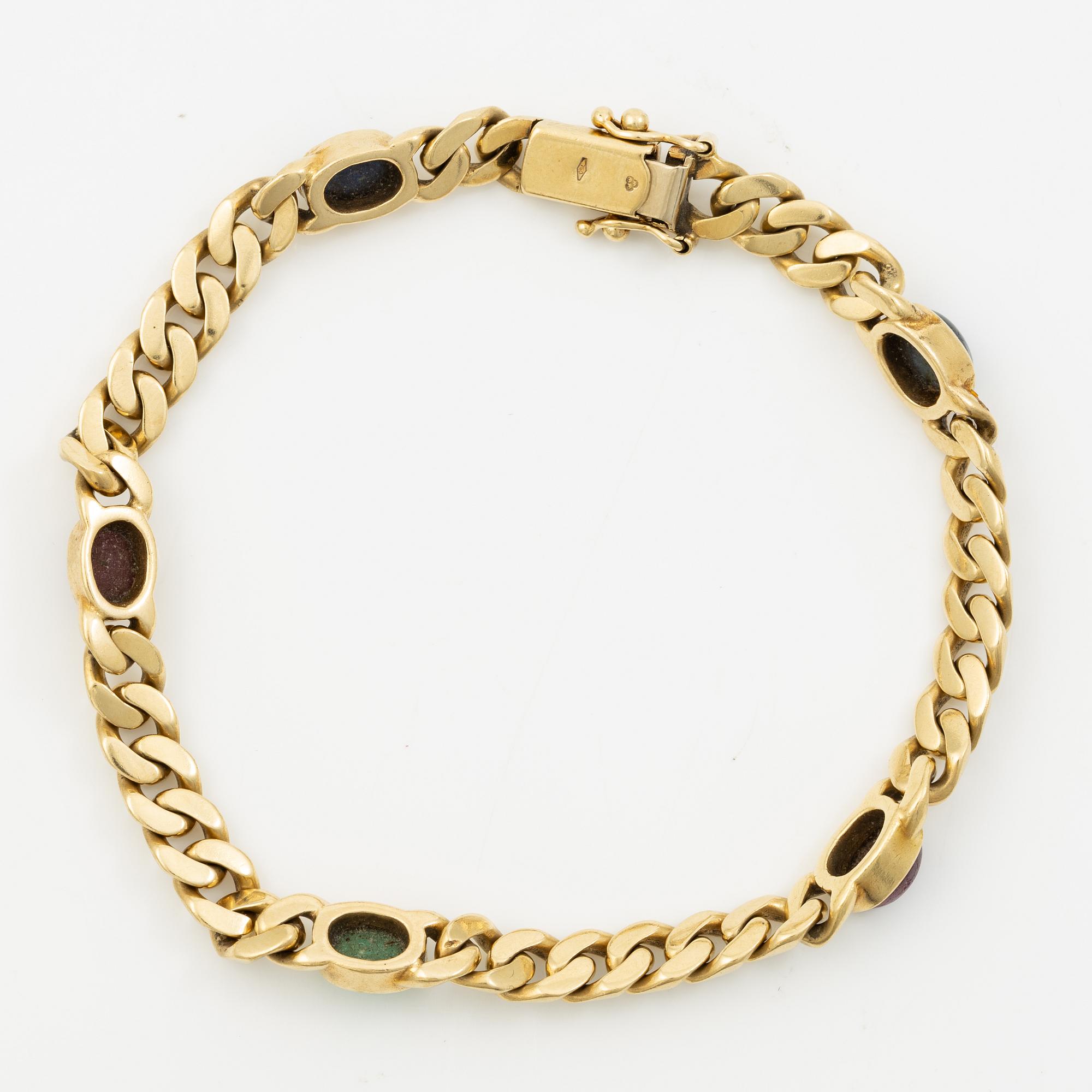 Bracelet in 18K gold set with cabochon-cut emeralds, rubies, and sapphires.