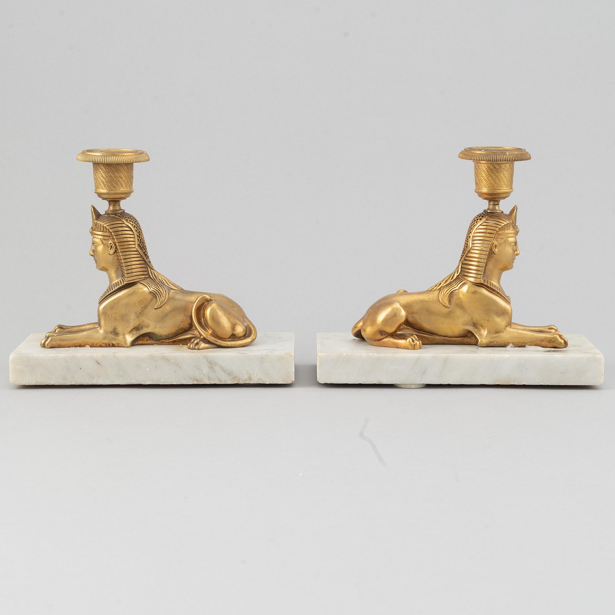 A pair of empire style 19th century candlesticks.