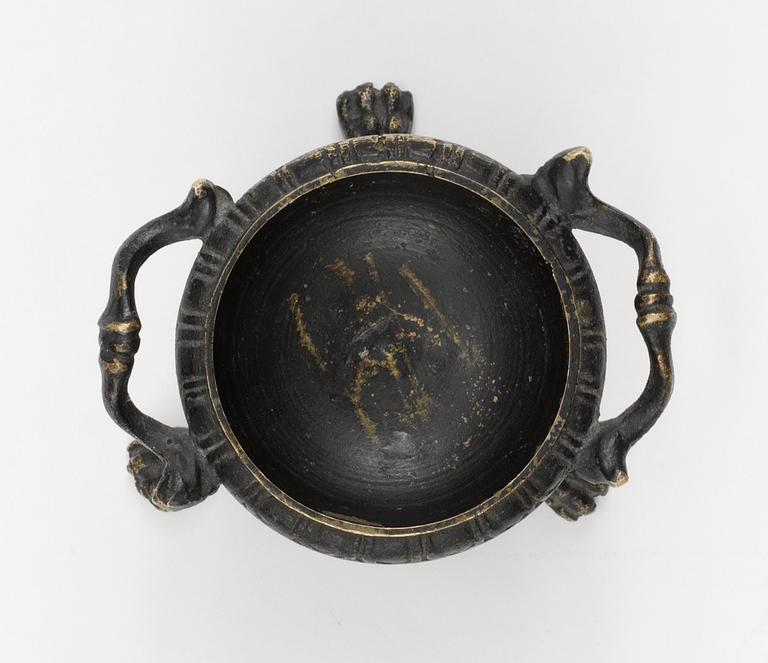 A bronze salt cellar.