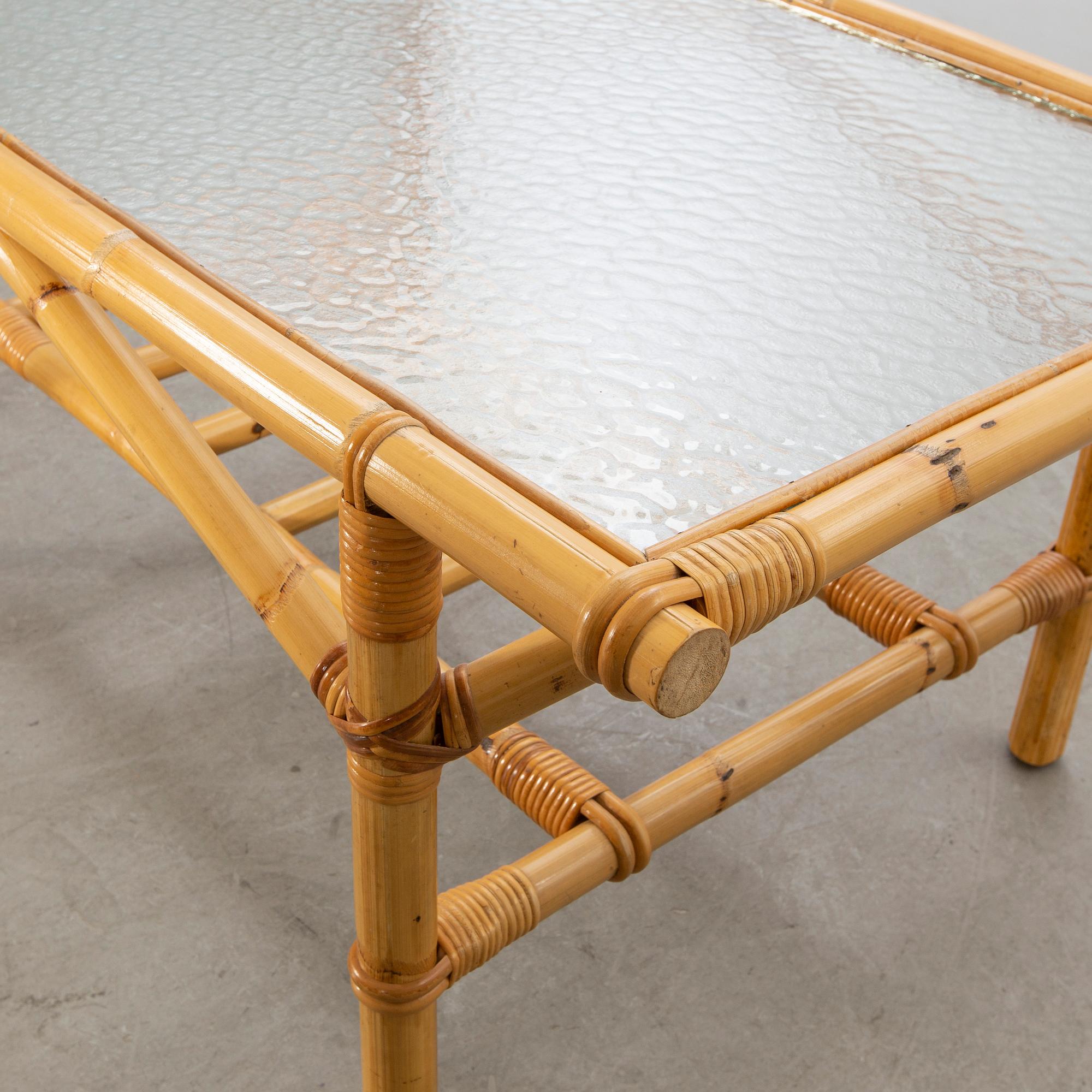 A set of ratten furniture, late 20th century; sofa, armchairs and a lounge table.