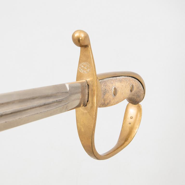 A Swedish sabre 1899 pattern with scabbard with another sword.