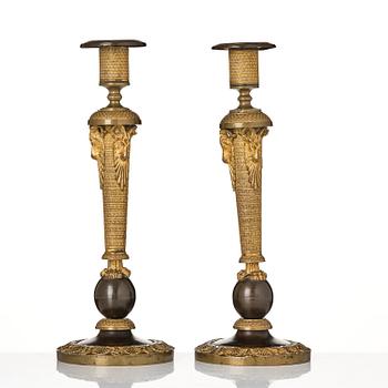 A pair of Russian Empire ormolu and patinated bronze candlesticks, Moscow circa 1800.