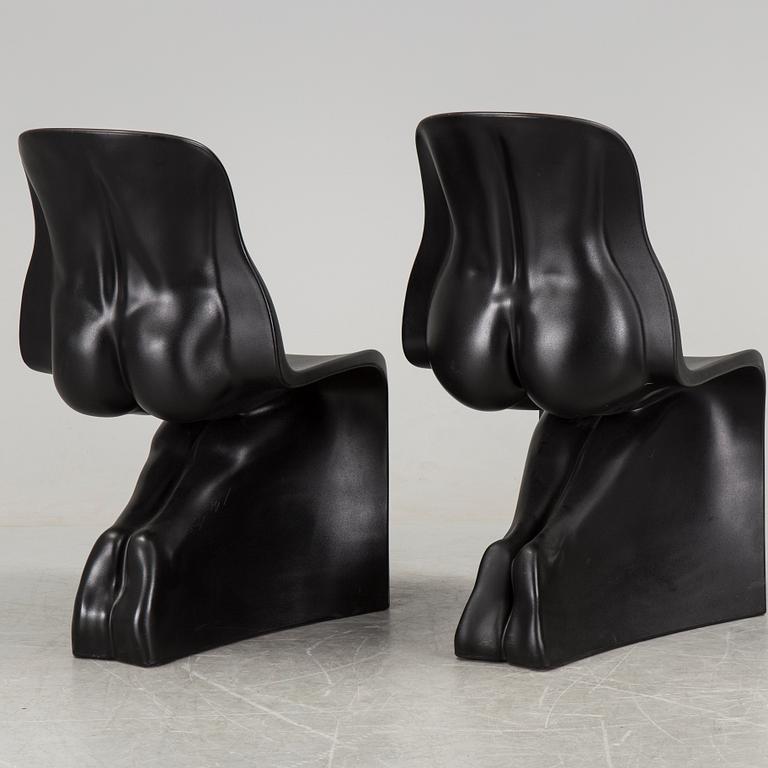 a pair of Italian black plastic chairs designed by Fabio Novembre "Him" and "Her" from the late 20th Century.