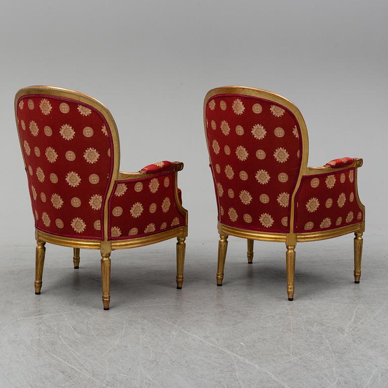 A pair of Louis XVI-style armchairs.