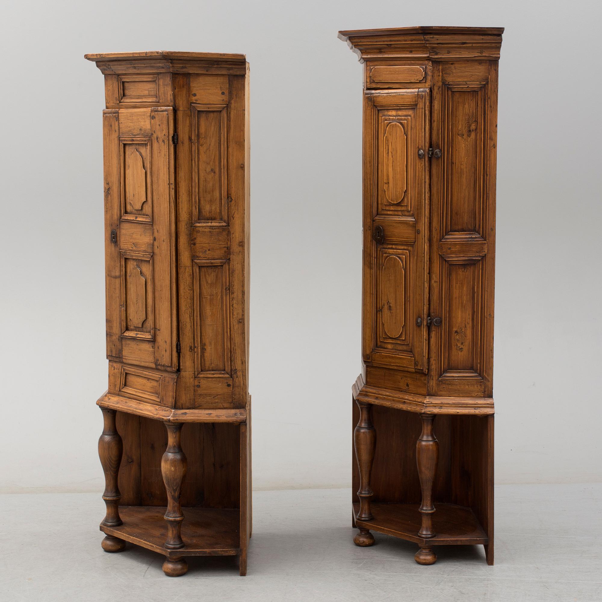 Two 18th century wooden corner cabinets.