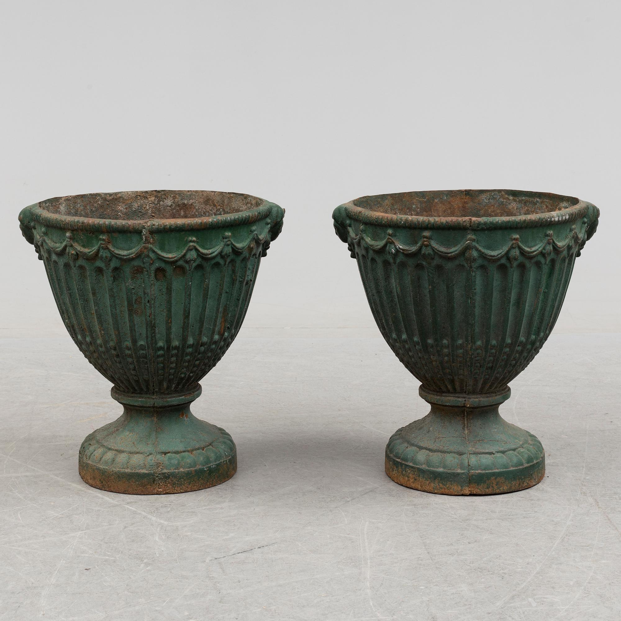 A pair of early 20th century iron garden urns.