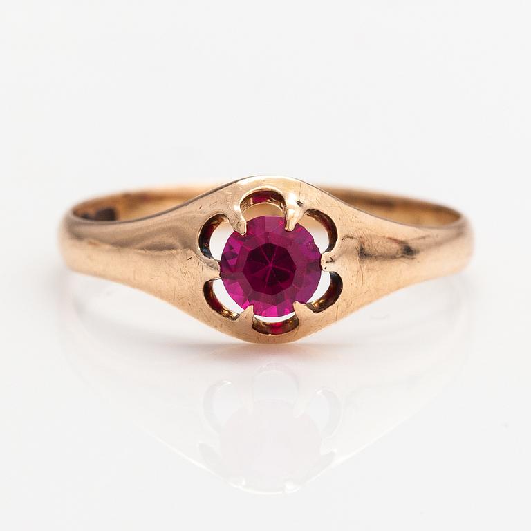 A 14K gold ring with a synthetic ruby.