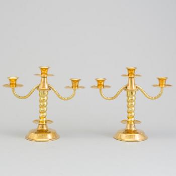 a pair of brass candelabras by Gottfrid Carlsson Eskilstuna.