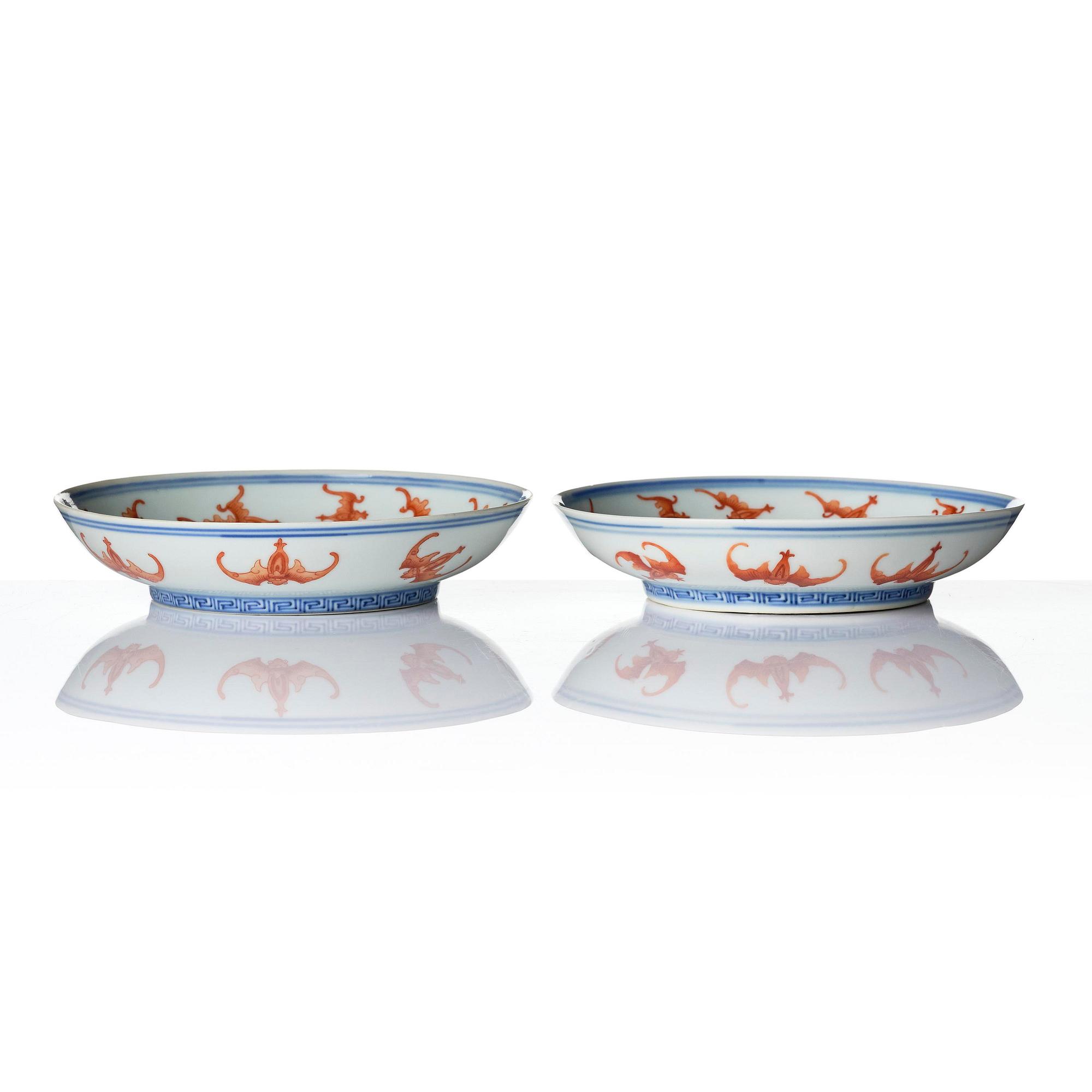 A pair of iron-red decorated 'bats' dishes, Qing dynasty, Guangxu mark and period (1875-1908).