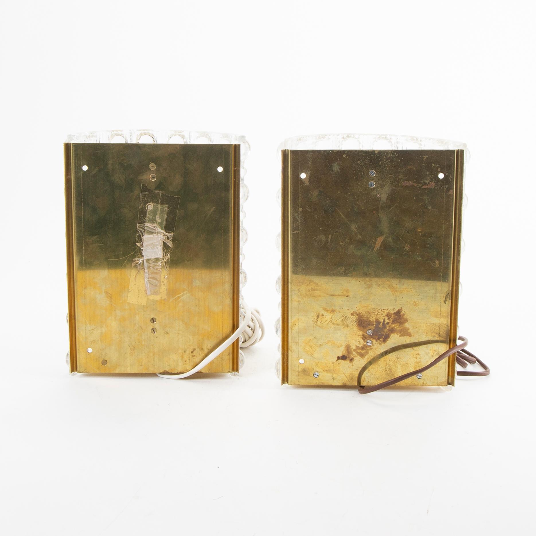 A pair of Carl Fagerlund glass and brass walls cones from Orrefors 1970s.