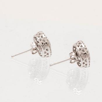 A pair of 14K white gold earrings set with round single-cut diamonds.