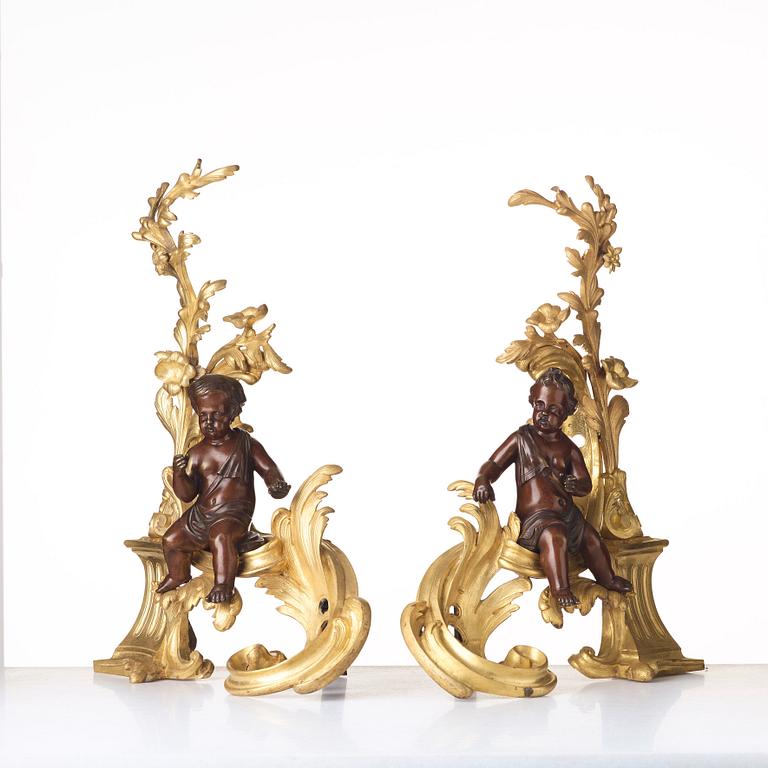 A pair of Louis XV-style 19th century fire dogs.