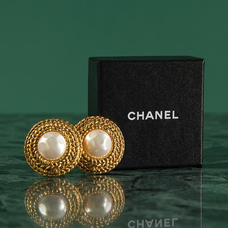 Earclips by Chanel.