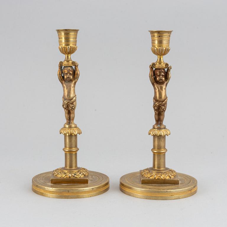 A pair of 19th Century bronze empire style candlesticks.