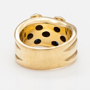 An 18K gold ring with rubies and sapphires. Import marked Torbjörn Tillander, Helsinki 1991.