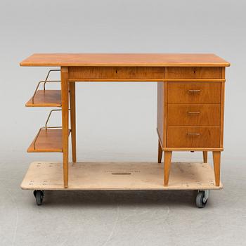 A teak veneered desk, 1950's.