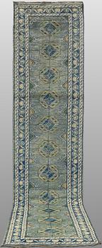 An Oriental runner, c. 393 x 79 cm.