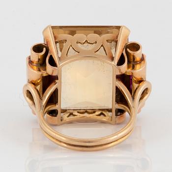 A 14K gold ring set with a faceted citrine and rubies.