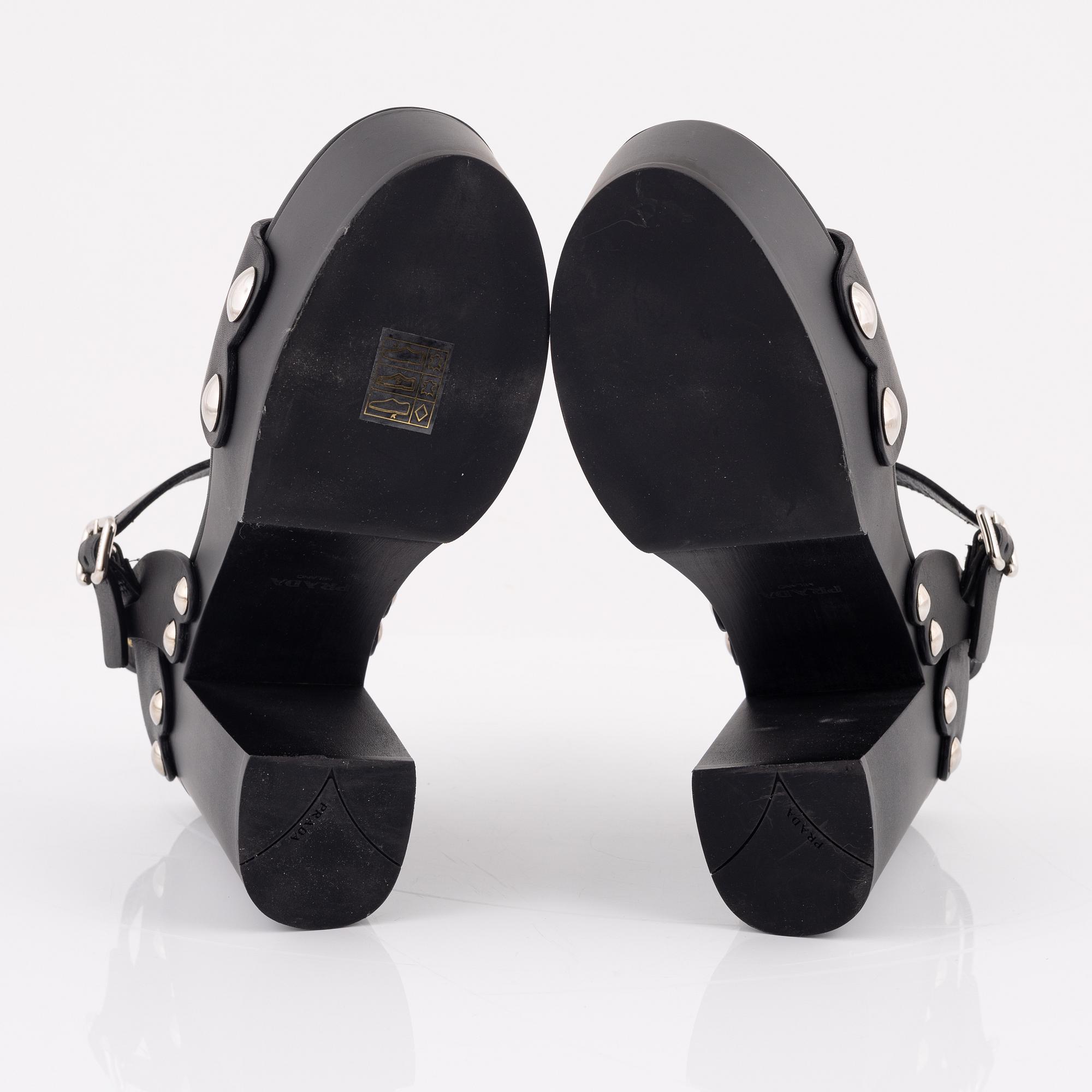 Prada, a pair of wood and leather sandals, size 37.