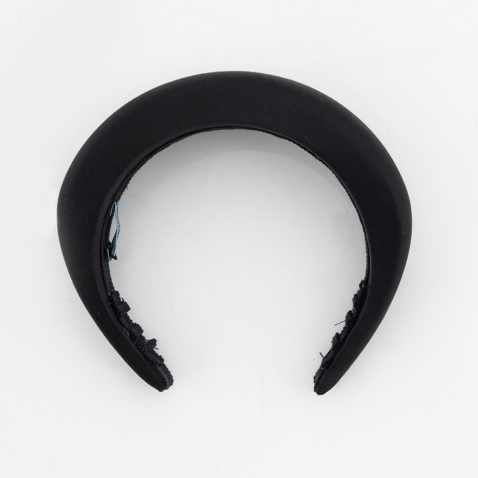 Prada, a black silk hair accessory.