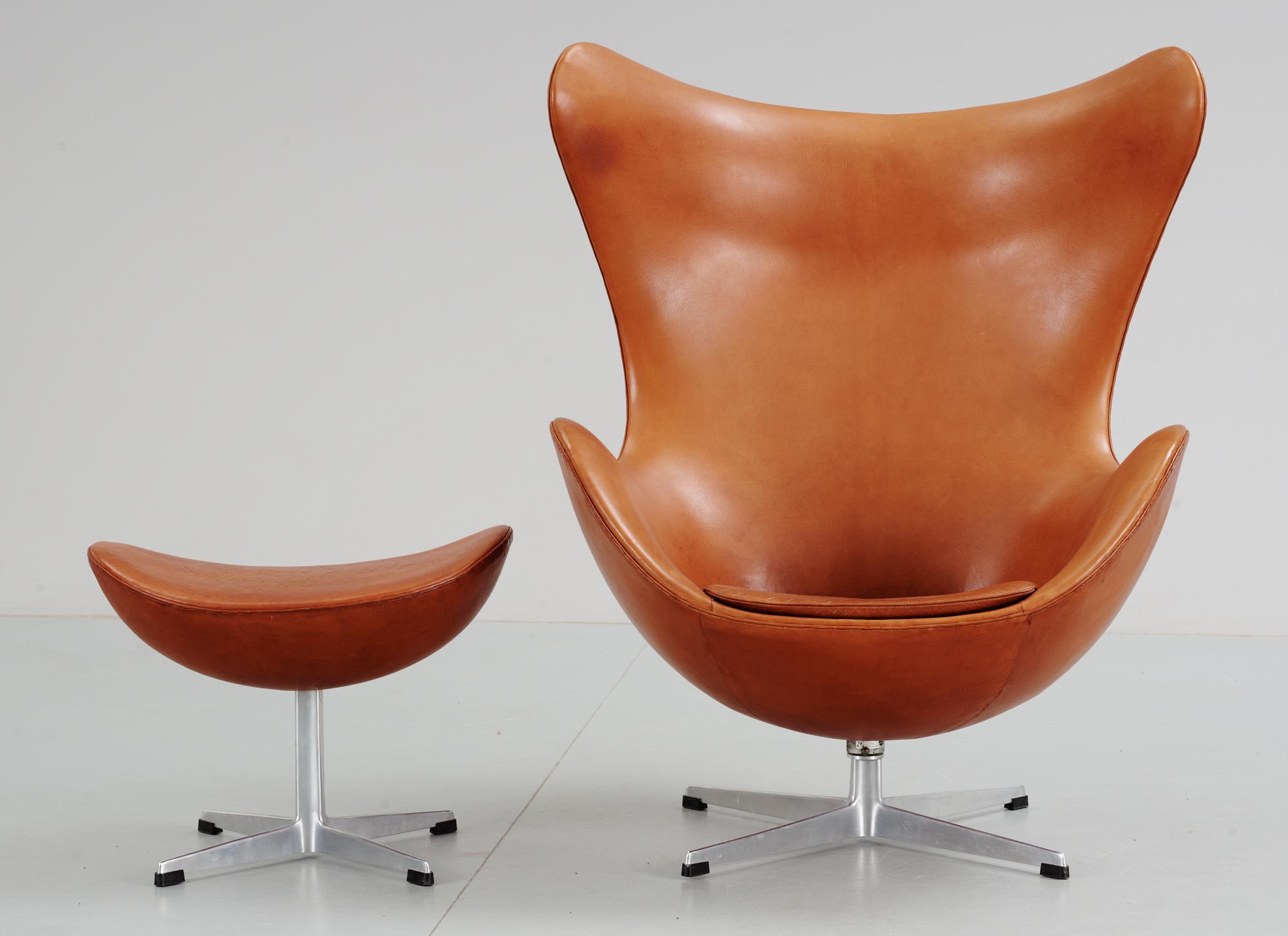 An Arne Jacobsen brown leather 'Egg' chair and ottoman, Fritz Hansen, Denmark 1963.
