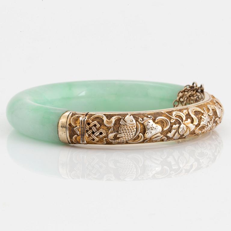 A jadeite and silver bracelet.