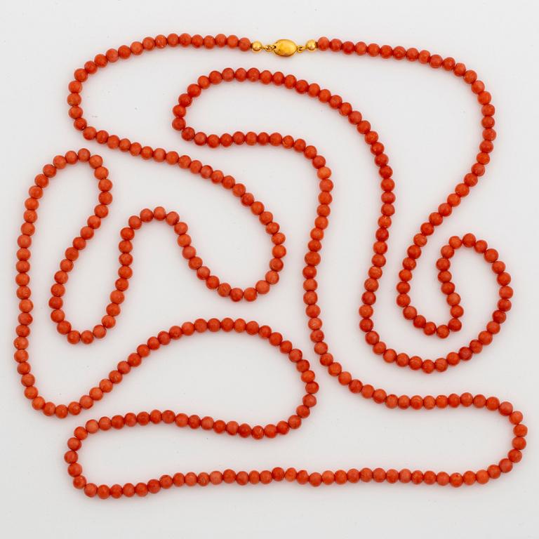 A coral necklace with a 14K gold clasp.