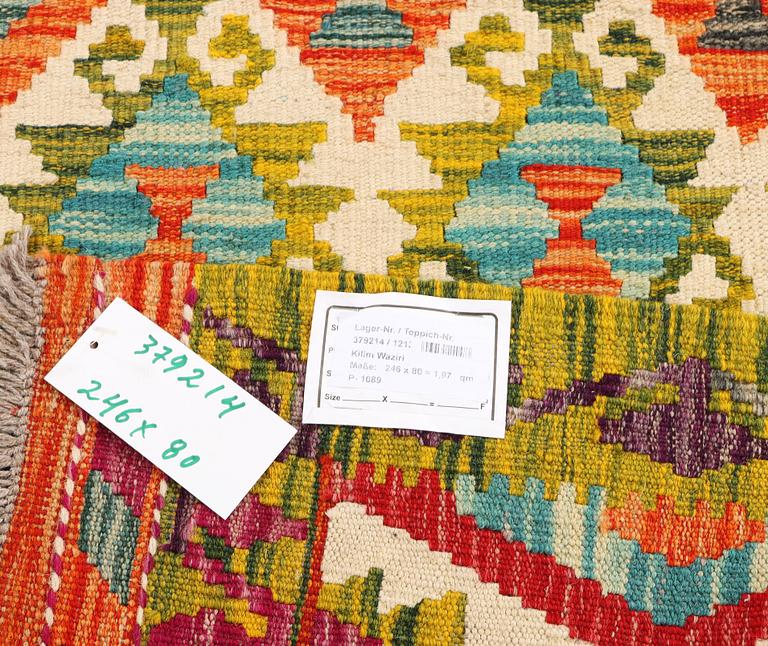 An Afghan kilim rug, c. 246 x 80 cm.