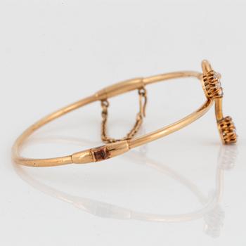 A 14K gold bangle set with old- and rose-cut diamonds.