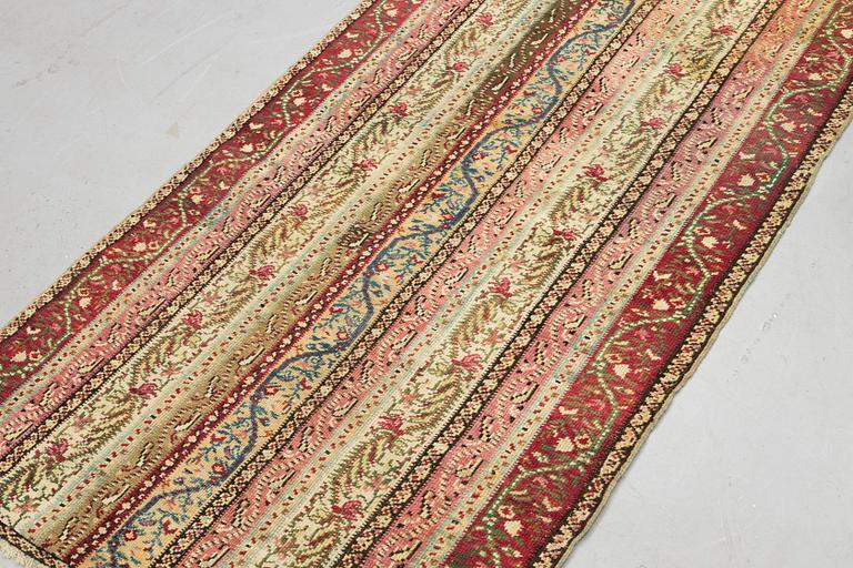 A rug, antique Gördes (Ghiordes), ca 206 x 113 cm.