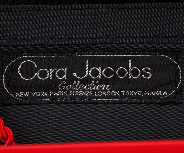 CORA JACOBS, a red silk and embossed leather clutch / evening bag.