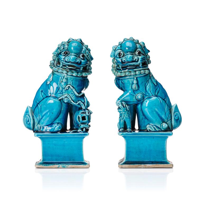 A pair of Chinese turquoise glazed buddhist lions, Qing dynasty, 18th Century.