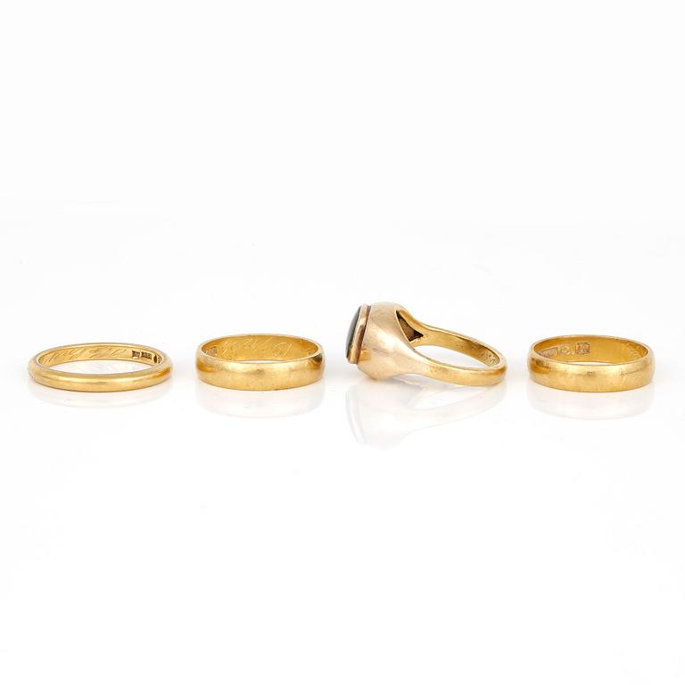 RINGAR, 4 st, 23K guld med sannolikt syntetisk grön spinell, Stockholm, 1900-tals. Total vikt ca 24,40 g.