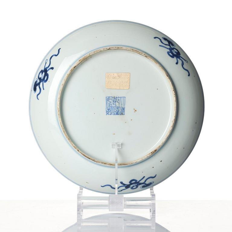 A blue and white lotus dish, Qing dynasty with a Qianlong mark and of the period (1736-95).