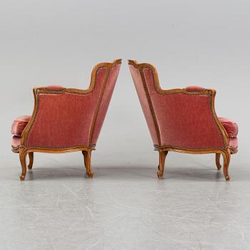 A pair of rococo style easy chairs from around the year 1900.