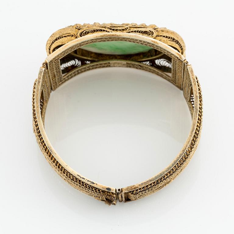A gilded silver bracelet with stone inlay, late Qing dynasty.